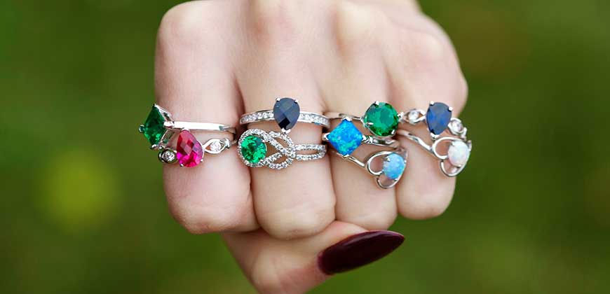 hand with colorful gem rings