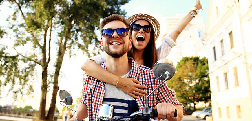 couple wearing jewelry safely on moped