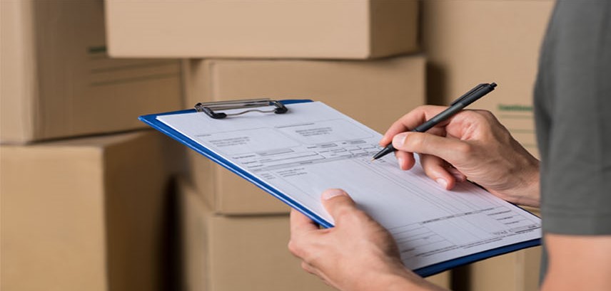 Signing paperwork with mailing boxes