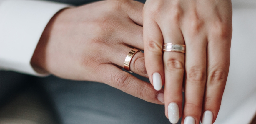 Close up of hands with wedding rings on