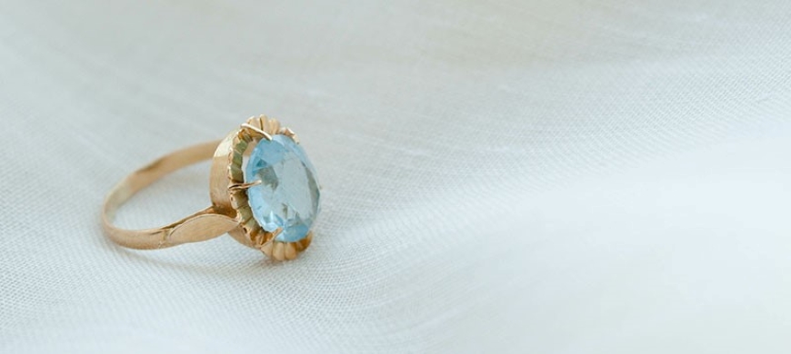 Picture of an aquamarine ring on a white cloth
