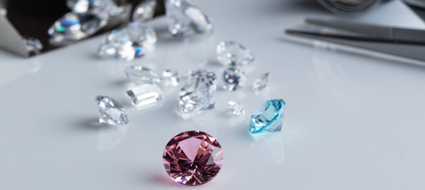 Pink and blue gemstone with diamonds