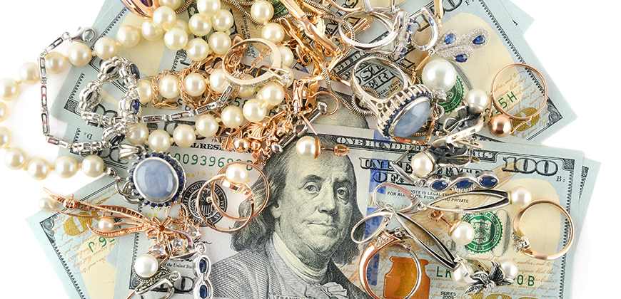 Jewelry on top of $100 bills