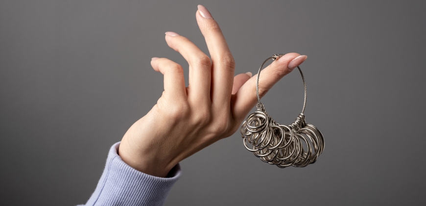 Hand holding a ring sizer tool