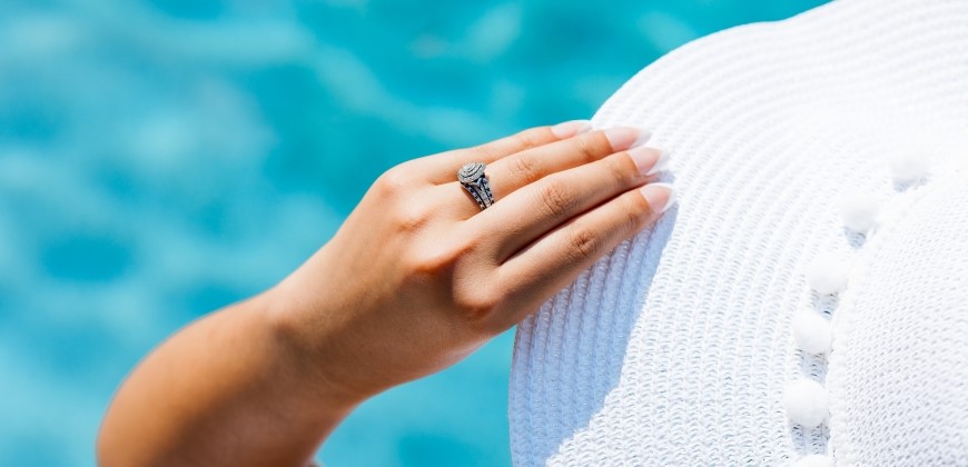Person wearing an engagement ring by the water