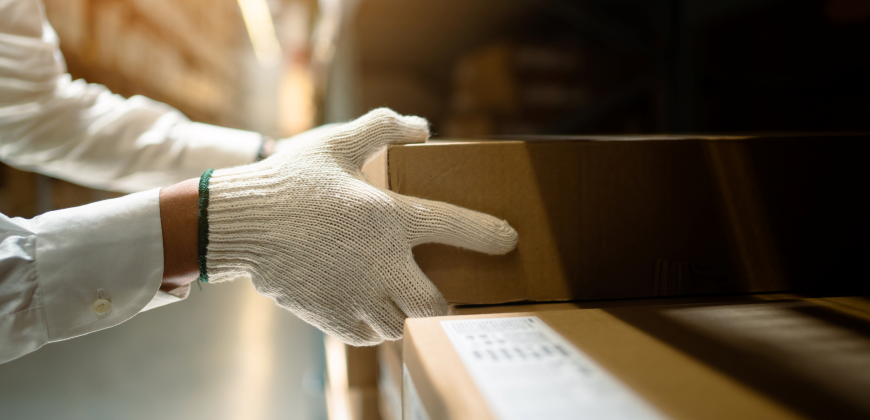 Hands holding a box in a shipping room