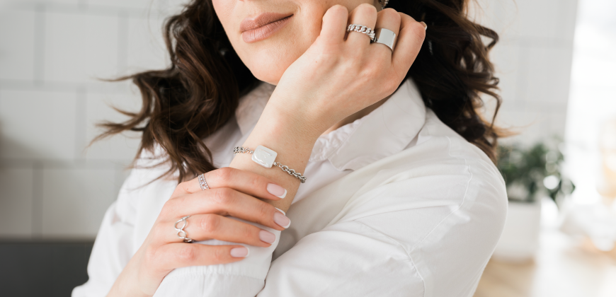 Woman wearing multiple silver rings and a bracelet