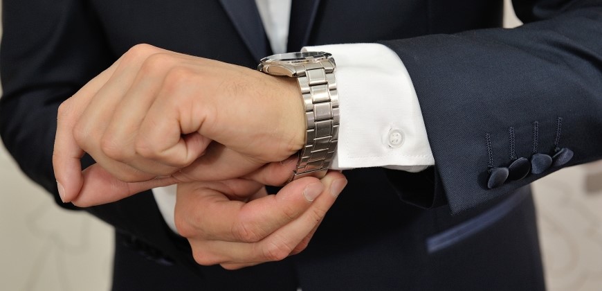 Person with a silver watching adjusting the fit