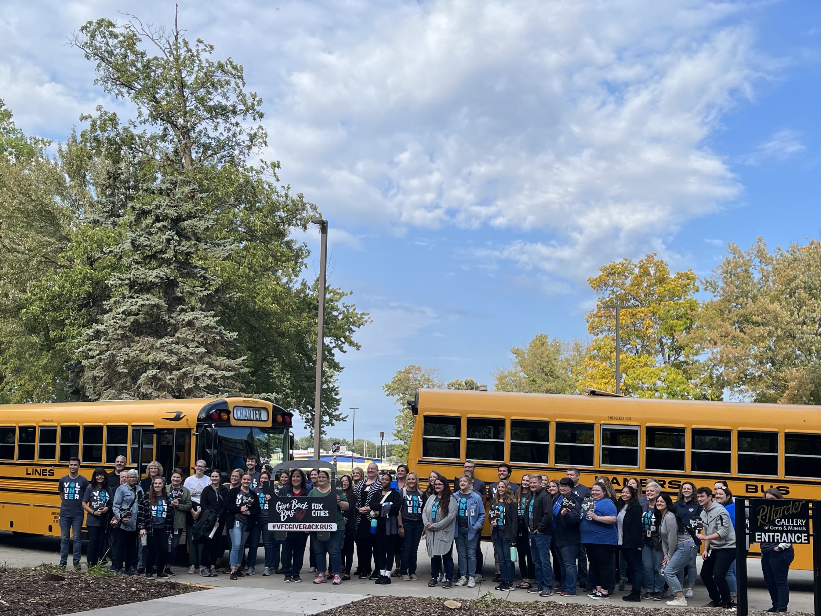 Employees in front of the Give Back Bus