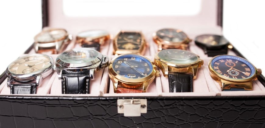 Ten watches close up in a storage box