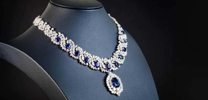 Diamond and sapphire statement necklace on a black necklace stand