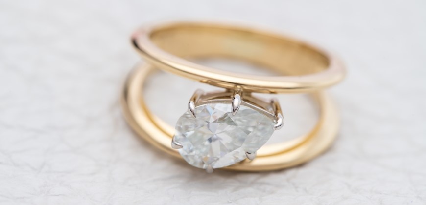 A gold ring with a white diamond