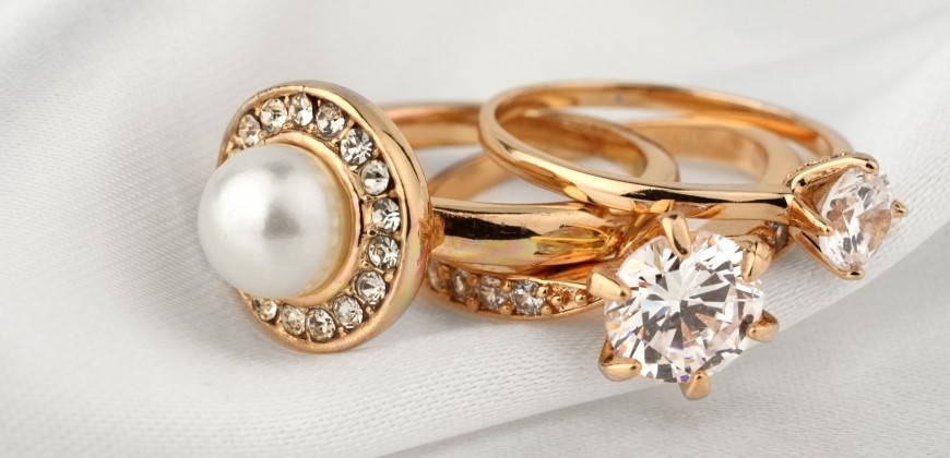 Three gold and diamond rings stacked on top of each other