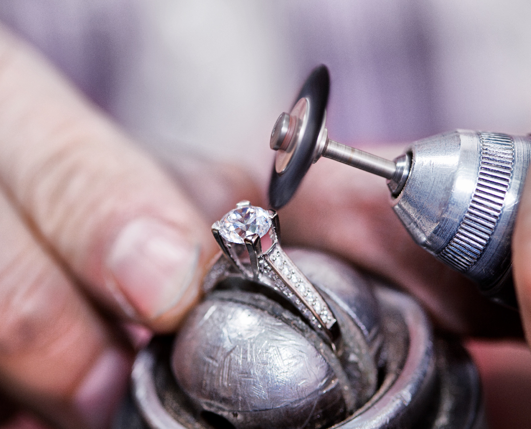 Jeweler using a tool on a diamond ring