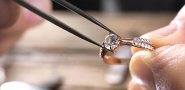 Jeweler using a tweezers to fix a diamond ring