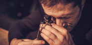Jeweler looking at a diamond ring close up using a tool