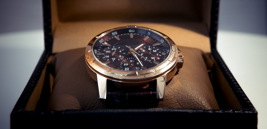 Gold and black watch in a box close up