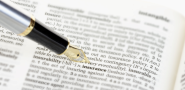 Pen pointing at insurance in the dictionary