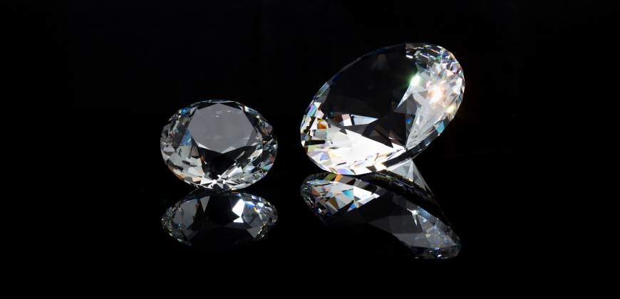 Two gemstones that look like diamonds on a black background