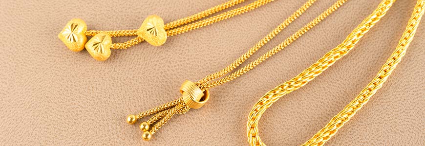 3 gold plated necklaces with varying charms and chains