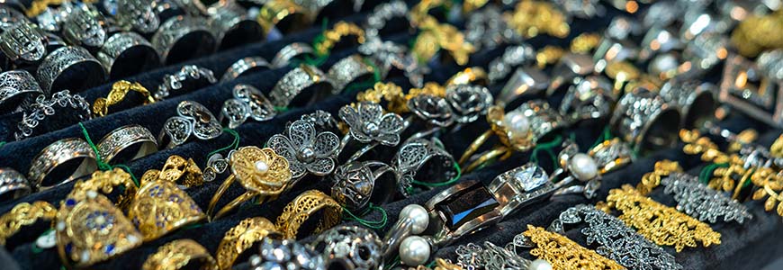 large jewelry display of gold and silver filigree jewelry and rings