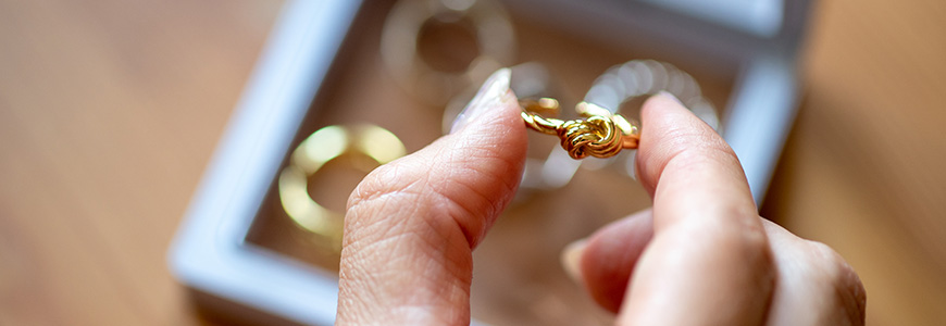 woman grabs gold ring out of jewelry box
