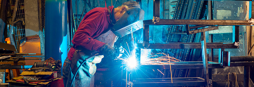 blacksmith working at blacksmith worktable