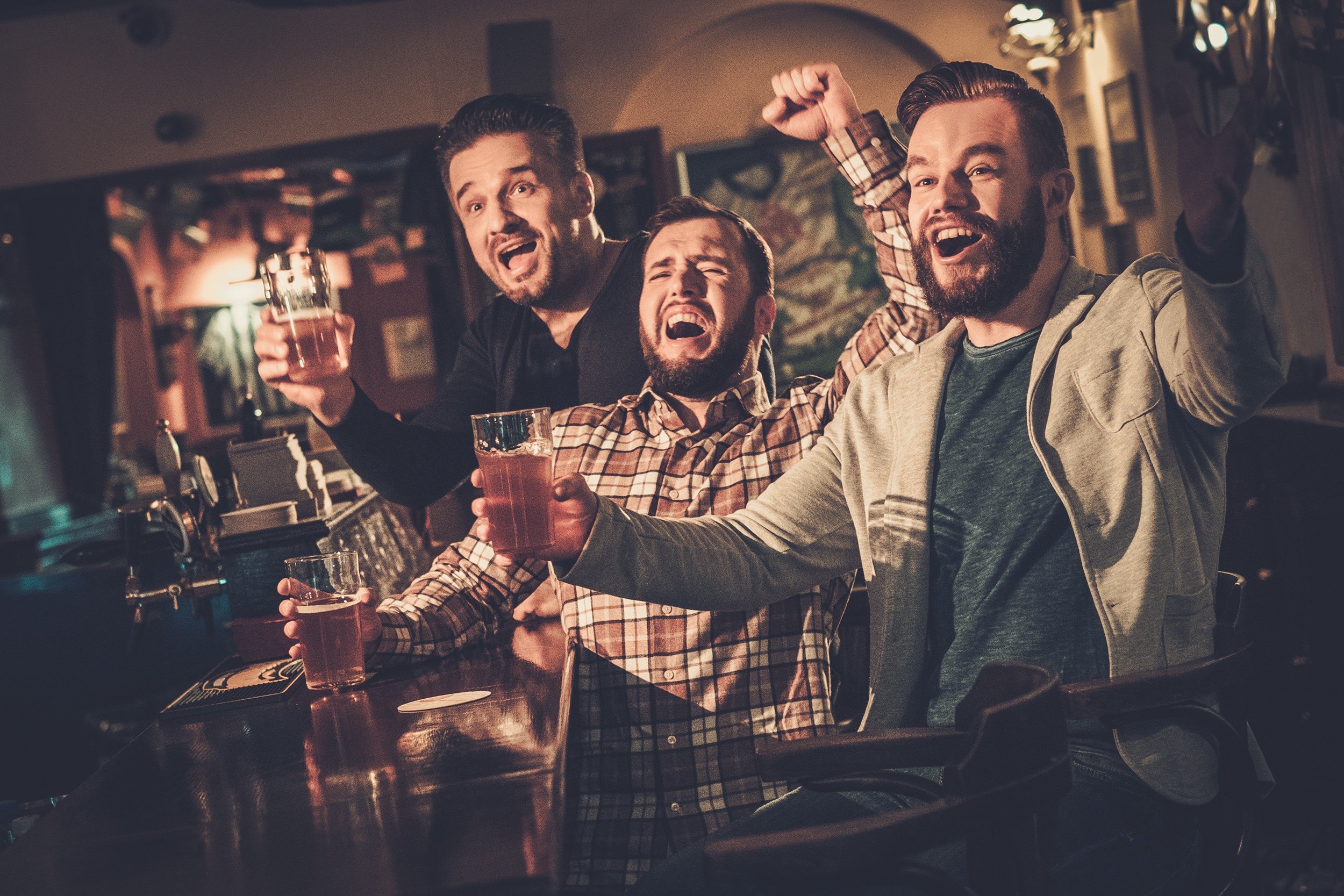 Guys watching sports at a bar