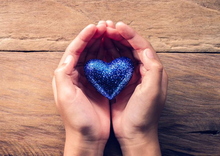 Picture of hands holding a blue heart