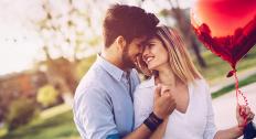 couple holding heart balloon