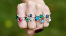 Colored gemstones rings on fingers feature
