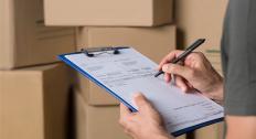 Signing paperwork with mailing boxes