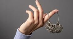Hand holding a ring sizer tool