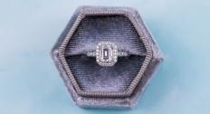 Engagement ring in a box with a blue background