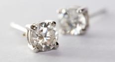 Two pairs of earrings on a white background