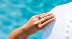 Person wearing an engagement ring by the water
