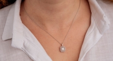 Persona wearing a diamond pendant