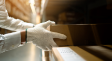 Hands holding a box in a shipping room
