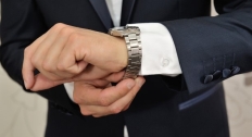 Person with a silver watching adjusting the fit