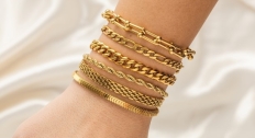 Six different style gold bracelets stacked
