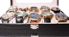 Ten watches close up in a storage box
