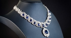 Diamond and sapphire statement necklace on a black necklace stand