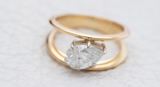 A gold ring with a white diamond 