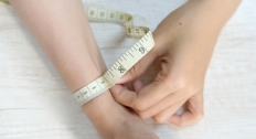 A person measuring their wrist size