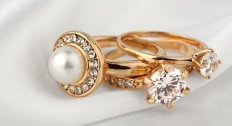 Three gold and diamond rings stacked on top of each other
