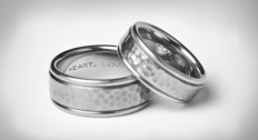 Two hammered wedding bands stacked with engravings inside