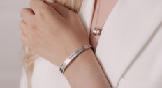 Close up of someone wearing a silver bracelet and necklace