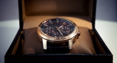 Gold and black watch in a box close up