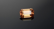 A zircon gemstone up close on a black and grey background