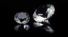Two gemstones that look like diamonds on a black background